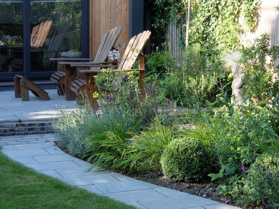 Terrace outside garden buiding & adirondack chairs